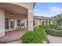 Home exterior featuring a charming covered front porch, front door and meticulous landscaping at 6617 Nautical Dr, Lakewood Ranch, FL 34202