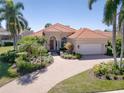 Beautiful single-story home with well-manicured landscaping and a brick driveway, perfect for enjoying the Florida lifestyle at 7141 Whitemarsh Cir, Lakewood Ranch, FL 34202