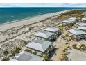 Aerial view of the beachfront properties with a communal pool nestled within the community at 7490 Palm Island Dr # 2324, Placida, FL 33946