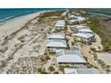 Expansive aerial shot showcases beachfront condos along the coastline with beach access at 7490 Palm Island Dr # 2324, Placida, FL 33946