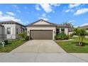 Charming single-story home featuring a well-maintained lawn and a two-car garage at 8619 Firefly Pl, Parrish, FL 34219