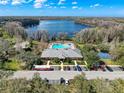 Aerial view of the community pool and clubhouse, set against a beautiful lake backdrop at 11805 Castine St, New Port Richey, FL 34654