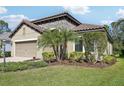 Beautiful home featuring a tile roof, manicured landscaping, and neutral paint scheme at 1604 Still River Dr, Venice, FL 34293