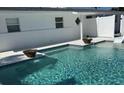 Beautiful pool with water features complemented by a minimalist white exterior at 2180 Orchid St, Sarasota, FL 34239