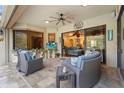 Covered patio with comfortable seating and sliding glass doors leading to the interior at 2515 130Th E Ave, Parrish, FL 34219