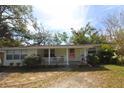 Lovely single-story home featuring a cozy front porch and well-maintained yard at 2696 Loma Linda St, Sarasota, FL 34239