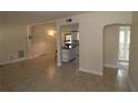 Open-concept living room showcasing tile floors and easy access to the kitchen at 2696 Loma Linda St, Sarasota, FL 34239