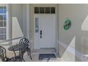 Cozy porch view with table and chairs next to the front door and a 'Welcome' sign at 3335 Brooklyn Ave, Port Charlotte, FL 33952