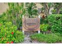 Bayshore on the Lake Clubhouse sign surrounded by lush greenery at 3658 Lake Bayshore Dr # 320, Bradenton, FL 34205