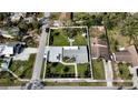 Aerial view of the property, showcasing its landscaped yard, patio, and neighborhood surroundings at 4218 S Lockwood Ridge Rd, Sarasota, FL 34231