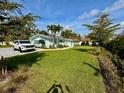 Beautiful single-story home with lush green lawn, landscaping, patterned driveway, and a walkway at 4218 S Lockwood Ridge Rd, Sarasota, FL 34231