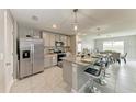Well-equipped kitchen with stainless steel appliances, granite countertops and seating at bar at 4411 Hearthstone Run, Palmetto, FL 34221