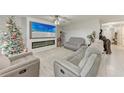 Cozy living room featuring comfortable seating, a fireplace, and a large-screen TV at 4411 Hearthstone Run, Palmetto, FL 34221