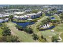 Aerial view of a condo community with a swimming pool, golf course, and scenic landscaping at 4530 Pinebrook W Cir # 309, Bradenton, FL 34209