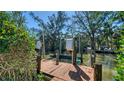 Private wooden dock with boat lift offering serene waterfront access and views at 462 Island Cir, Sarasota, FL 34242
