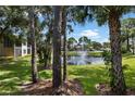 Scenic view of a community pond with a fountain, framed by lush trees and landscaping at 4655 46Th Street W Ct # 201, Bradenton, FL 34210