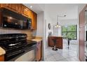 Well-equipped kitchen with a modern oven, granite countertops, and a stylish breakfast bar at 4655 46Th Street W Ct # 201, Bradenton, FL 34210