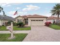Inviting home featuring a brick driveway, lush landscaping, and a charming mailbox at 5105 Pine Shadow Ln, North Port, FL 34287