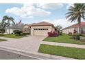 Lovely single Gathering home features a brick driveway and well manicured landscaping at 5105 Pine Shadow Ln, North Port, FL 34287