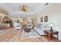 Inviting living room with wood floors, comfortable seating, and an open layout at 5105 Pine Shadow Ln, North Port, FL 34287