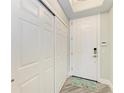Bright entryway featuring gray flooring, a closet, and a white front door at 5591 Cannes Cir # 403, Sarasota, FL 34231
