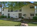 Inviting condo exterior with well-maintained landscaping, an open porch, and classic architecture at 5665 Midnight Pass Rd # 410, Sarasota, FL 34242
