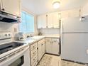 A functional kitchen with white cabinets and appliances, offering a practical cooking space at 5904 Palm Ln # C23, Bradenton, FL 34207