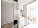 Cozy kitchenette area with white cabinets and view to dining area at 5904 Palm Ln # C23, Bradenton, FL 34207