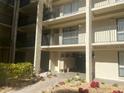 Condo building exterior featuring multiple balconies and well-maintained landscaping at 6157 Midnight Pass Rd # E42, Sarasota, FL 34242