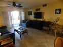 Comfortable living room with tile floors, opening onto balcony at 6157 Midnight Pass Rd # E42, Sarasota, FL 34242