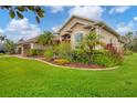 Lovely home showcasing manicured landscaping, a well-kept lawn, and architectural details at 6211 90Th Avenue E Cir, Parrish, FL 34219