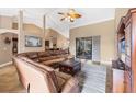 Spacious living room with high ceilings, a leather sectional, and sliding glass doors to the lanai at 6211 90Th Avenue E Cir, Parrish, FL 34219