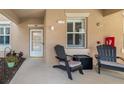Charming condo patio with Adirondack chairs creating a cozy and inviting outdoor space at 923 Fairwaycove Ln # 103, Bradenton, FL 34212