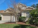 Charming two-story home with a well-manicured lawn, complemented by a two-car garage and traditional design at 1155 Millbrook Cir, Bradenton, FL 34212