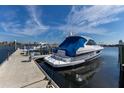 A luxurious Regal boat docked at a private slip, covered in a navy canvas under a cloudy sky at 1318 3Rd Street E Cir, Palmetto, FL 34221
