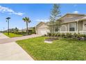 A single-story home with a brick driveway and well-manicured lawn at 1524 Remington Trace Dr, Port Charlotte, FL 33953