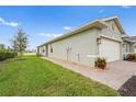 Features a well-maintained lawn and brick pathway at 1524 Remington Trace Dr, Port Charlotte, FL 33953