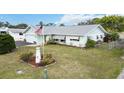 Charming single-story home features a well-manicured front lawn and an American flag at 1582 Overbrook Rd, Englewood, FL 34223
