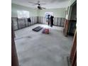 Bright living room undergoing renovations, featuring exposed walls, concrete flooring, and natural light at 1782 Mississippi Ne Ave, St Petersburg, FL 33703