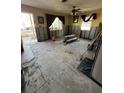View of a living room undergoing renovation with exposed walls and concrete flooring at 1782 Mississippi Ne Ave, St Petersburg, FL 33703