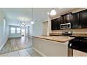 Modern kitchen with stainless steel appliances, dark cabinets and granite countertops at 1819 Redmond Brook Ln, Ruskin, FL 33570