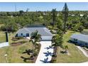Expansive aerial view showcasing the home's well-kept lawn and landscaping with ample surrounding greenery at 2466 Breakwater Cir, Sarasota, FL 34231