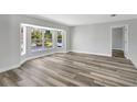 Spacious living room filled with natural light from a large bay window and stylish flooring at 3389 Dunbar St, Port Charlotte, FL 33948