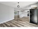 Open-concept layout features a bright kitchen and living space with modern flooring at 3389 Dunbar St, Port Charlotte, FL 33948
