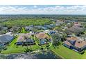 Aerial view of a charming home with a pool and surrounded by lush greenery, providing a serene retreat at 368 Snapdragon Loop, Bradenton, FL 34212