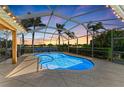 Sparkling pool with a screened enclosure is surrounded by lush landscaping and ample patio space at 368 Snapdragon Loop, Bradenton, FL 34212