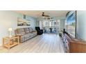 Cozy living room featuring wood-look floors, comfortable seating, and access to a private balcony at 3980 Ironwood Cir # 206, Bradenton, FL 34209