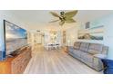 Bright and airy living room with wood-look floors, coastal decor, and views of the dining area at 3980 Ironwood Cir # 206, Bradenton, FL 34209