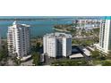 High-rise condo complex with ocean views, a pool, and covered parking at 435 S Gulfstream Ave # 1103, Sarasota, FL 34236