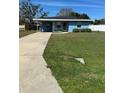 Inviting blue home with a long driveway and lush green lawn at 4511 Ardale St, Sarasota, FL 34232